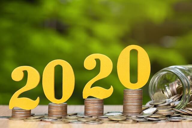 2020 pay raise: Numbers 2020 pictured horizontally on top of growing stacks of coins next to a glass jar tipped on its side with coins scattered around it