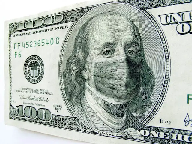 Close up of the image of Benjamin Franklin on a $100 bill wearing a face mask to protect from COVID-19 coronavirus