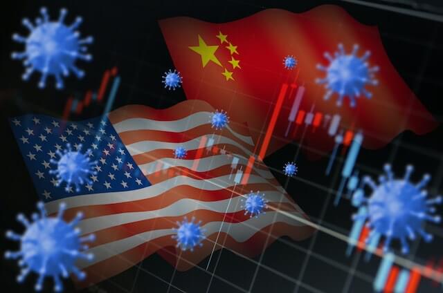COVID-19 coronavirus cells overlaid on top of the USA and China flags with a financial graph overlaid in the image