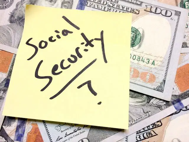 Spread of cash with a yellow post it note on top that reads 'Social Security?'