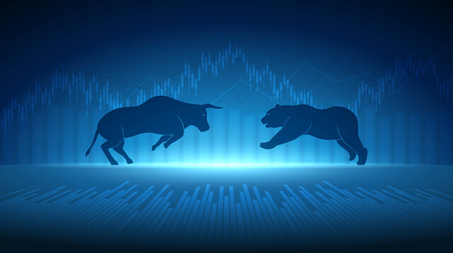 Illustration of a bull and a bear charging towards each other overlaid on top of a financial chart
