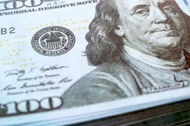 Close up of the face of Benjamin Franklin on the $100 bill