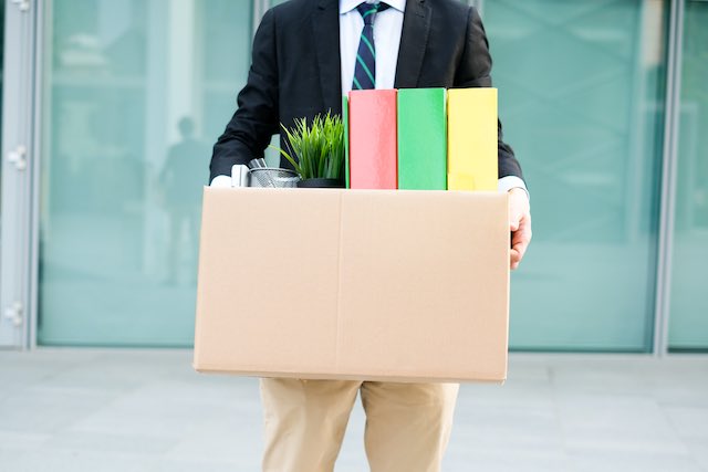 Employee who was fired/laid off/RIF carrying personal belongings in a box