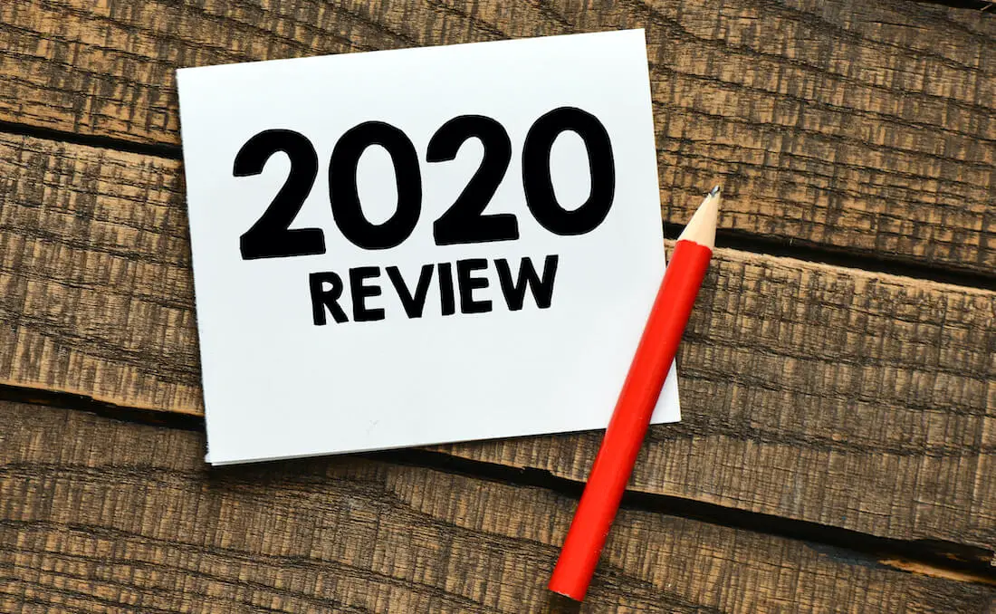 Words '2020 Review' written on an index card sitting on a wooden surface