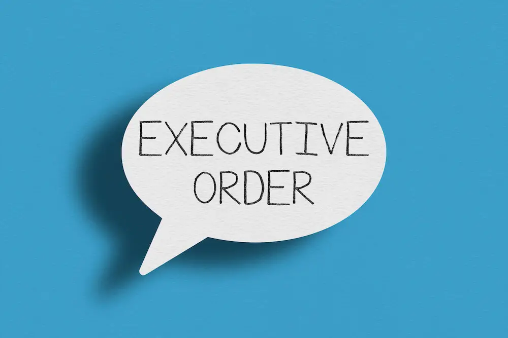 Words 'executive order' in a speech bubble against a blue background