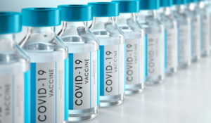Close up of a row of bottles of COVID-19 vaccines