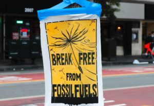 Pamphlet taped to a lamp post in San Francisco that reads 'break free from fossil fuels'