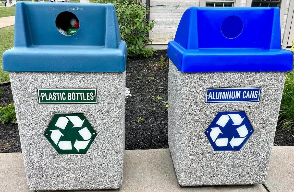 Two recycling bins pictured side by side, one for plastic and one for aluminum