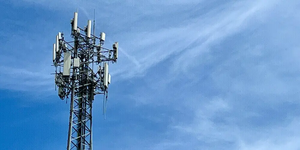 5G cell tower against a blue sky background