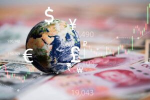 Small globe pictured on top of a spread of international currency