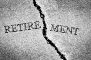 Word 'retirement' broken in half by a crack in concrete