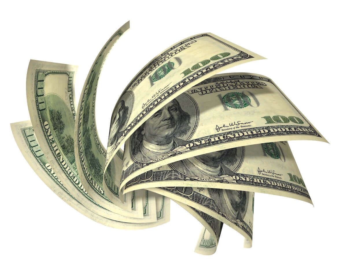 spread of cash in a rotating fan pattern against a white background