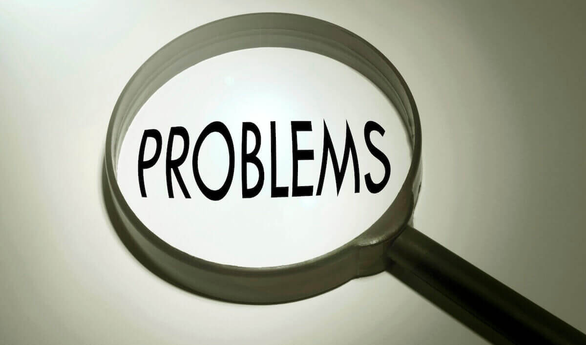 Word 'problems' in focus in a magnifying glass