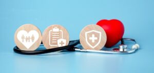 The concept of health insurance and medical welfare. Circle wood and red heart with icon.