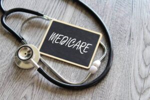 chalkboard with word 'medicare' written on it surrounded by a doctor's stethoscope