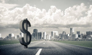 3D dollar sign on a road leading to a city in the distance