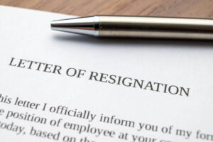 close up of a letterhead titled 'letter of resignation' with a pen on top of it