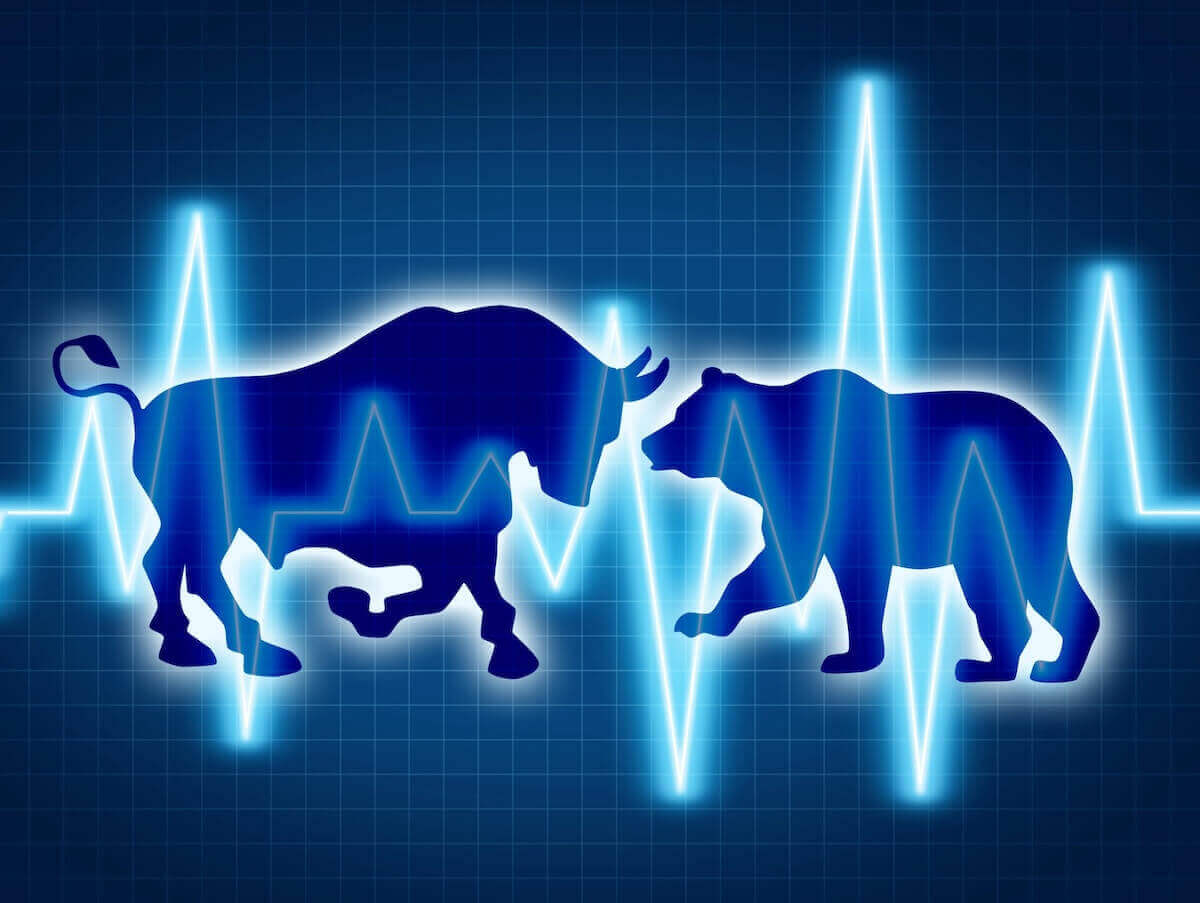 Silhouette of a bull and a bear behind a line graph