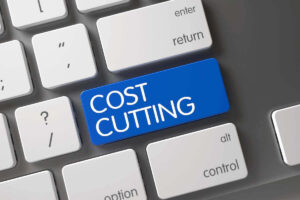 Blue key on a keyboard labeled 'cost cutting'