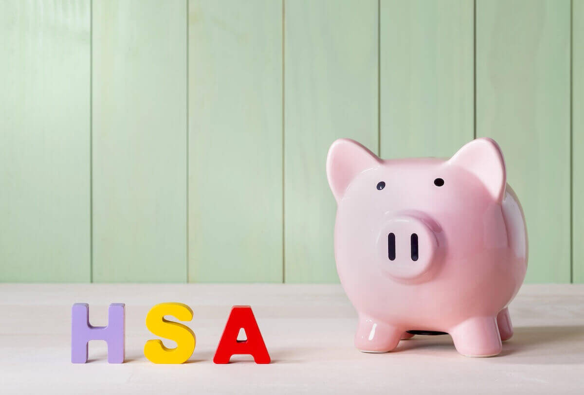 pink piggy bank picture next to colored block letters that spell 'HSA'