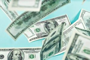 Spread of US dollars against a teal background