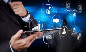 Businessman's hands holding a tablet with digital icons overlaid around it