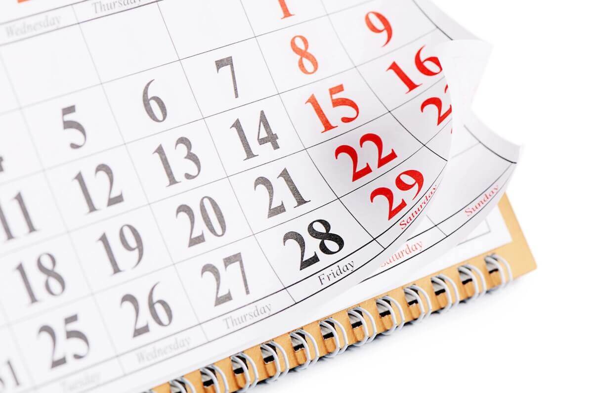 Calendar with bottom right part of page turning against a white background