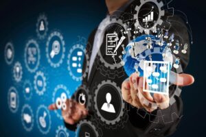 Businessman touching an icon with various other icons overlaid on the image