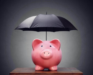 Umbrella over a pink piggy bank