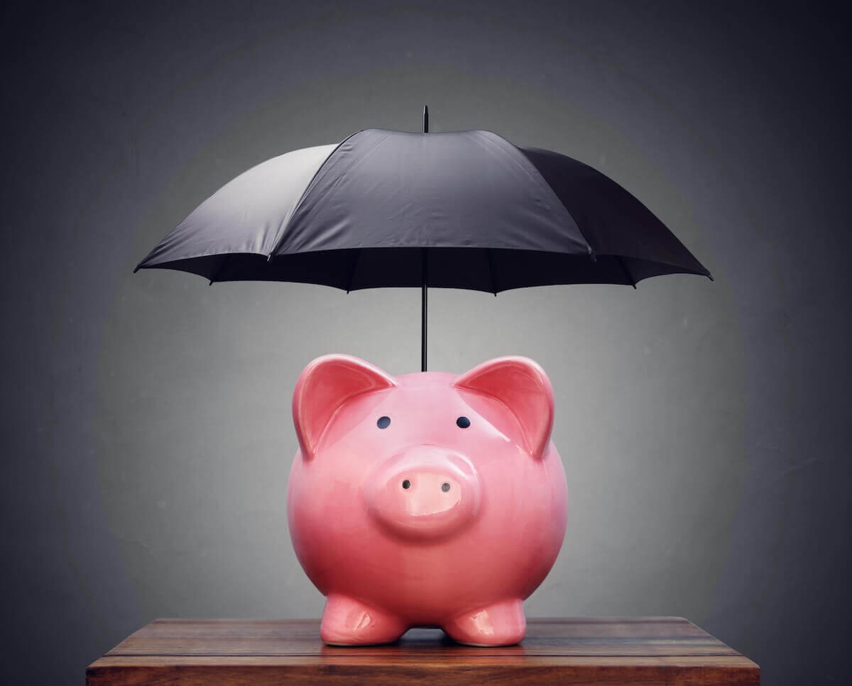 Umbrella over a pink piggy bank